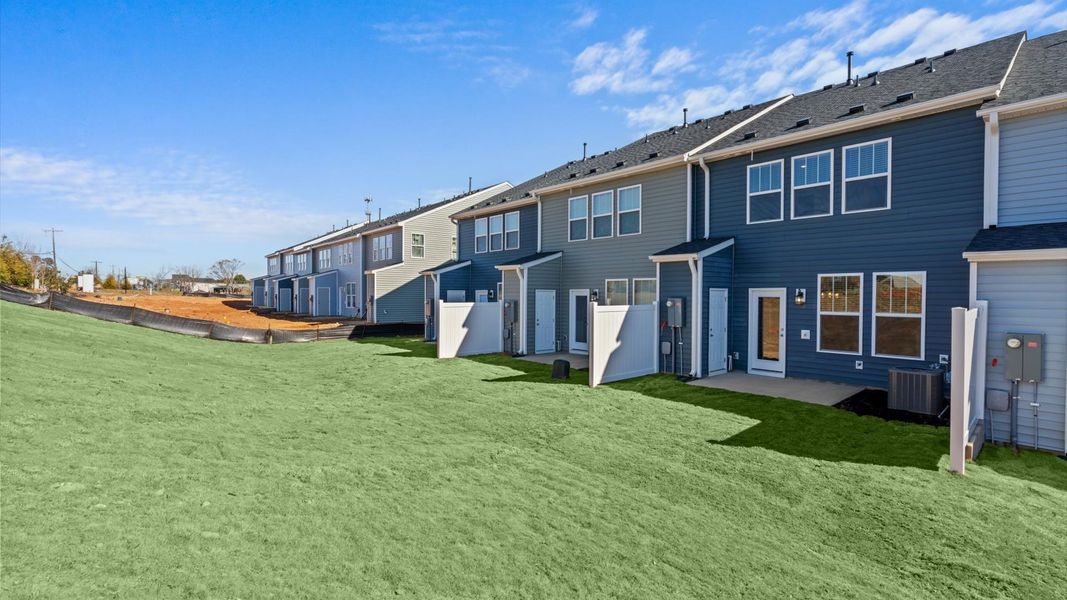 Refined rear exterior with a large backyard for relaxing or entertaining this townhome community, Silo Ridge