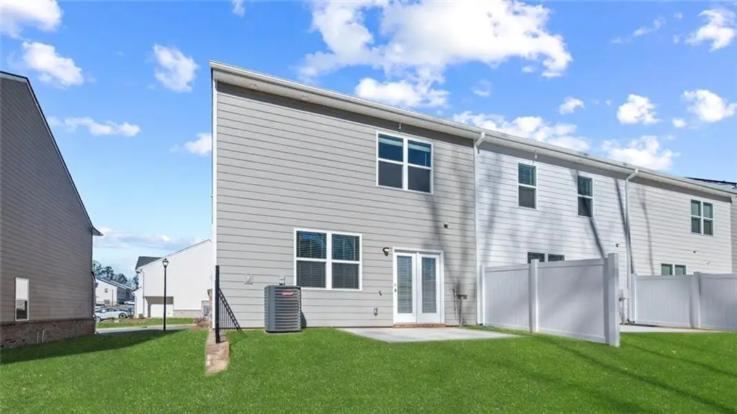 Exterior details and patio area of a home in Inverness at Sugarloaf, Lawrenceville (Image 4).