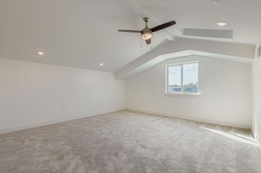 Additional living space featuring light colored carpet, recessed lighting, and a ceiling fan