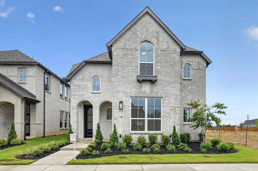 Front exterior of a new home in The Parks at Wilson Creek, Celina, TX, highlighting curb appeal (Image 1). Front exterior of a new home in The Parks at Wilson Creek, Celina, TX, highlighting curb appeal (Image 1).