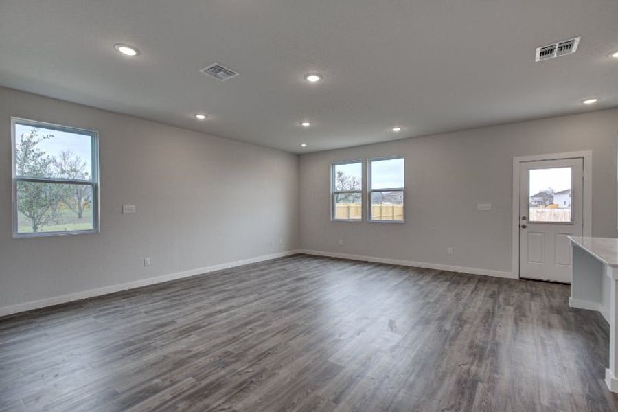 A room with windows and a wood floor. A room with windows and a wood floor.