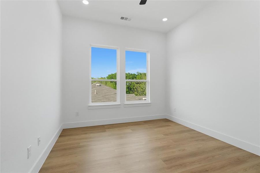 Spare room with light wood-style floors, recessed lighting, and ceiling fan