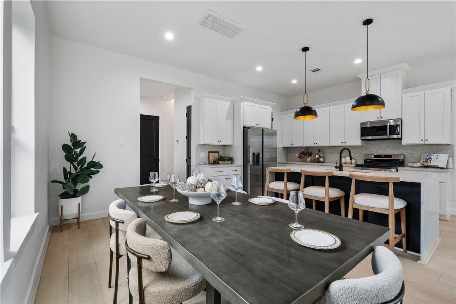 Seamless transition from dining to kitchen with modern cabinetry and clean finishes. Seamless transition from dining to kitchen with modern cabinetry and clean finishes.