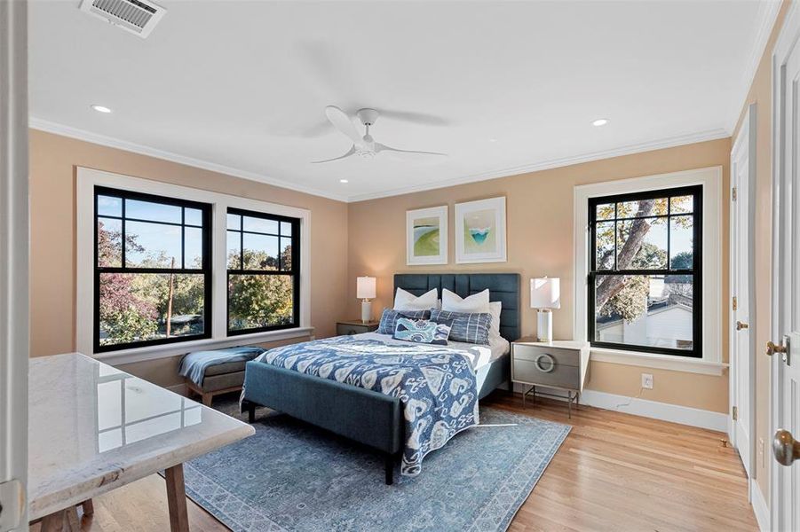 Bedroom featuring ceiling fan, light hardwood / wood-style flooring, and ornamental molding