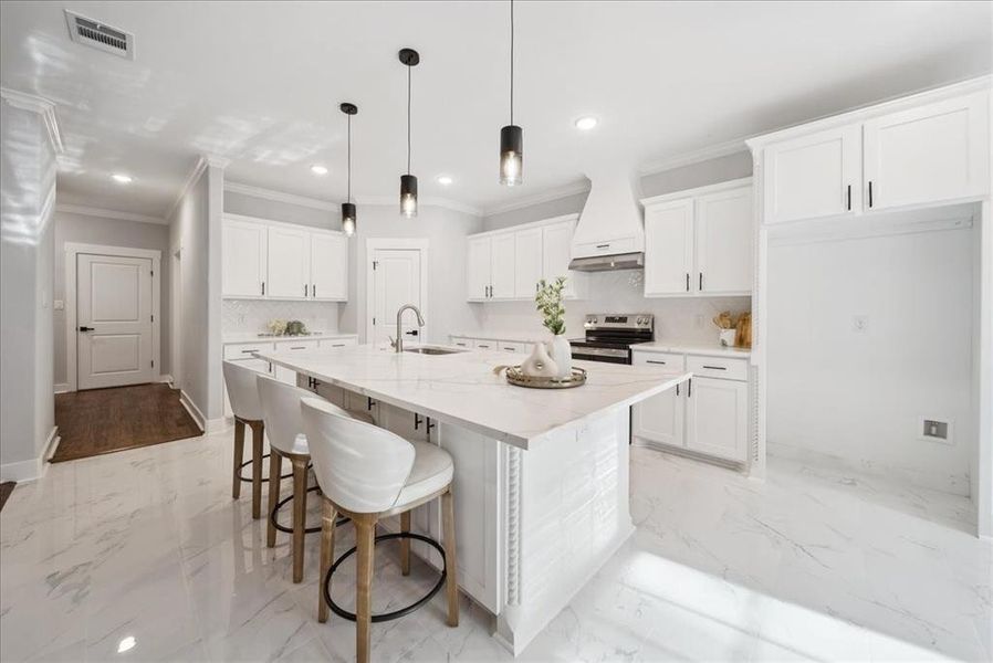 Kitchen with stainless steel range with electric stovetop, white cabinetry, an island with sink, and custom range hood