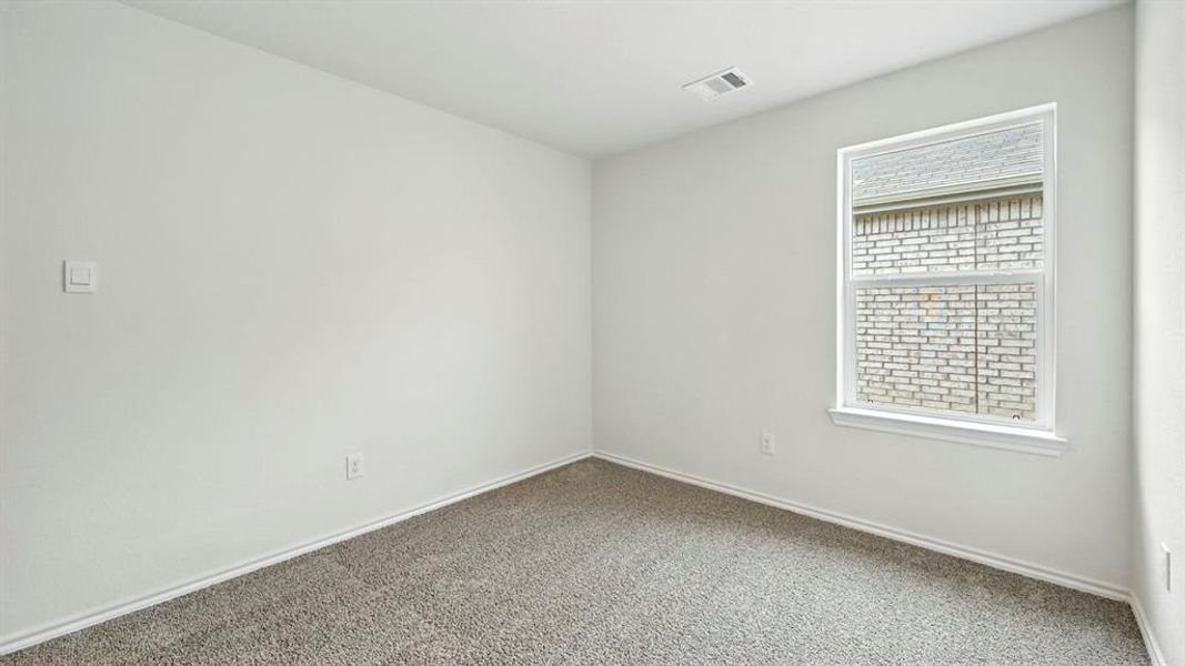 Carpeted room featuring a single window with white trim, a ceiling vent, and light-colored walls Carpeted room featuring a single window with white trim, a ceiling vent, and light-colored walls