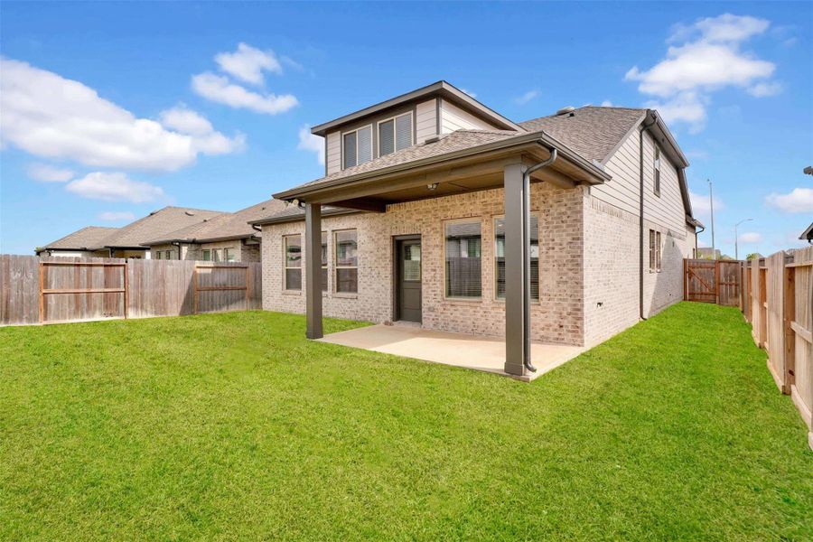 Large covered patio leading to backyard with plenty of side yard