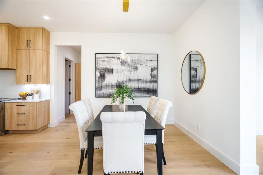 Dining area with light hardwood / wood-style flooring