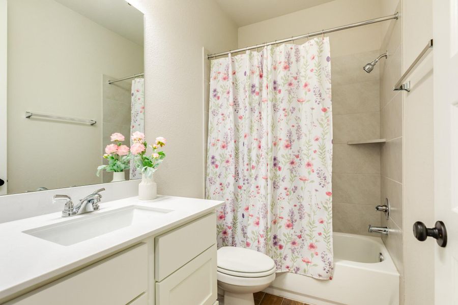 Secondary bathroom with quartz countertops, tub, and shower combo shared with the secondary bedrooms. Secondary bathroom with quartz countertops, tub, and shower combo shared with the secondary bedrooms.
