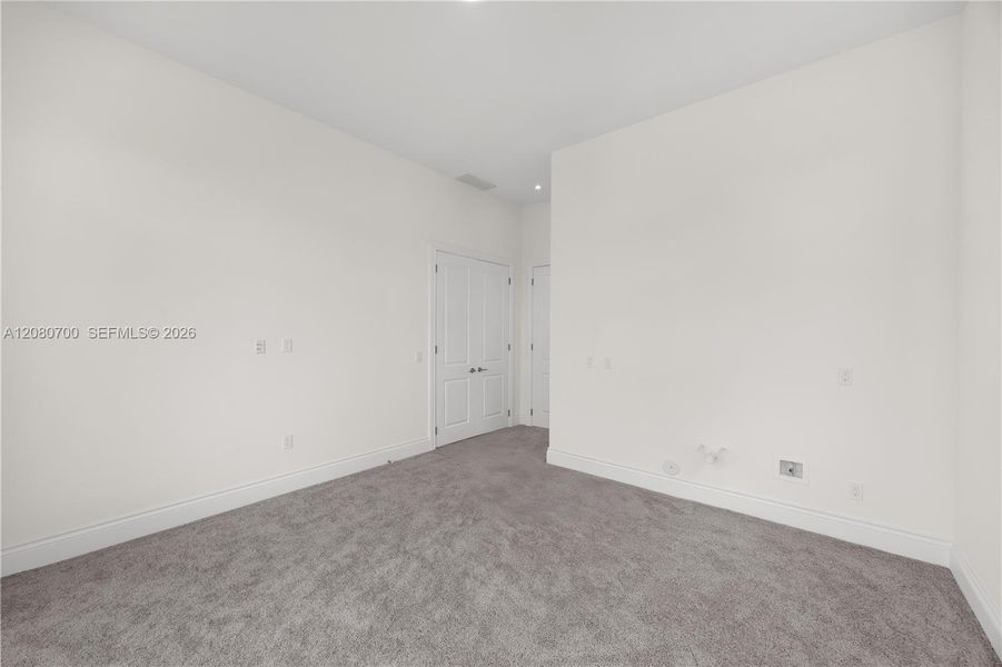 Recessed lighting, light gray wall-to-wall carpeting, and white interior doors