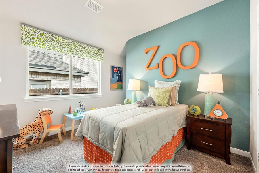 Children's bedroom with zoo theme, teal accent wall with orange letters, single bed, and stuffed animal toys Children's bedroom with zoo theme, teal accent wall with orange letters, single bed, and stuffed animal toys