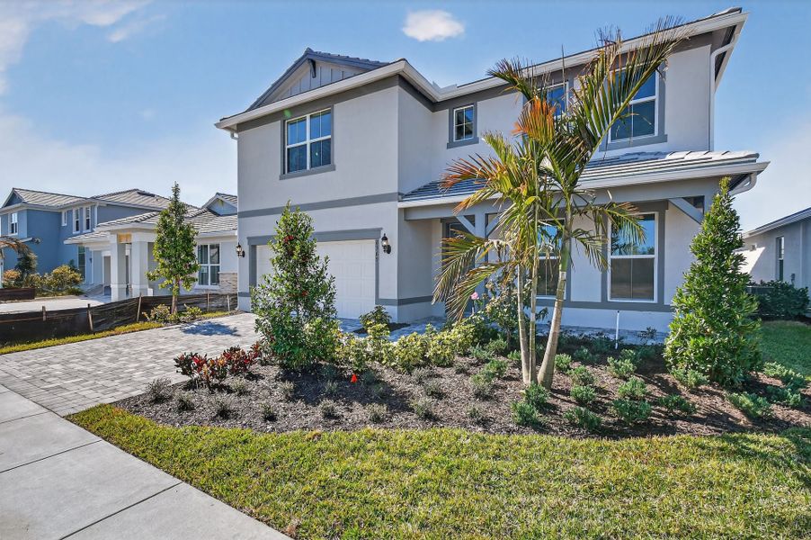 Front exterior of a new home in Harbor Isle, Vero Beach, FL, highlighting curb appeal (Image 28). Front exterior of a new home in Harbor Isle, Vero Beach, FL, highlighting curb appeal (Image 28).