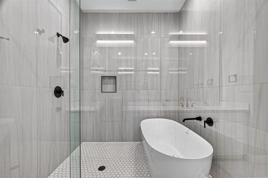 Stunning, spacious walk-in shower paired with a deep soaking tub. Stunning, spacious walk-in shower paired with a deep soaking tub.