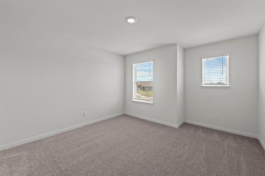 Carpeted spare room featuring baseboards Carpeted spare room featuring baseboards