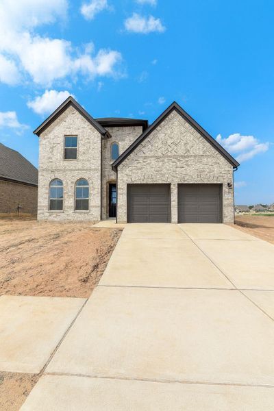 Front exterior of a new home in Escondido, Magnolia, TX, highlighting curb appeal (Image 1). Front exterior of a new home in Escondido, Magnolia, TX, highlighting curb appeal (Image 1).
