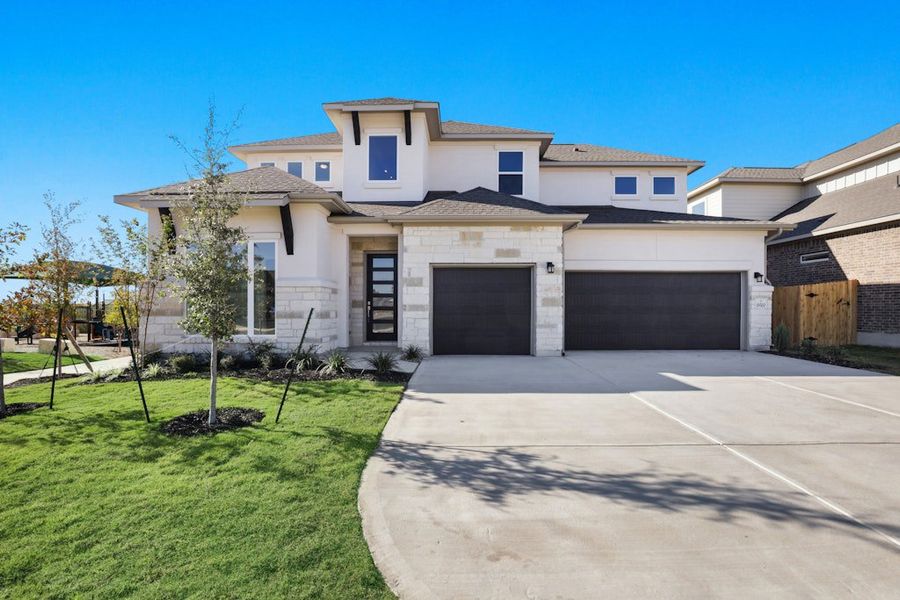 Front exterior of a new home in Blackhawk, Pflugerville, TX, highlighting curb appeal (Image 1). Front exterior of a new home in Blackhawk, Pflugerville, TX, highlighting curb appeal (Image 1).