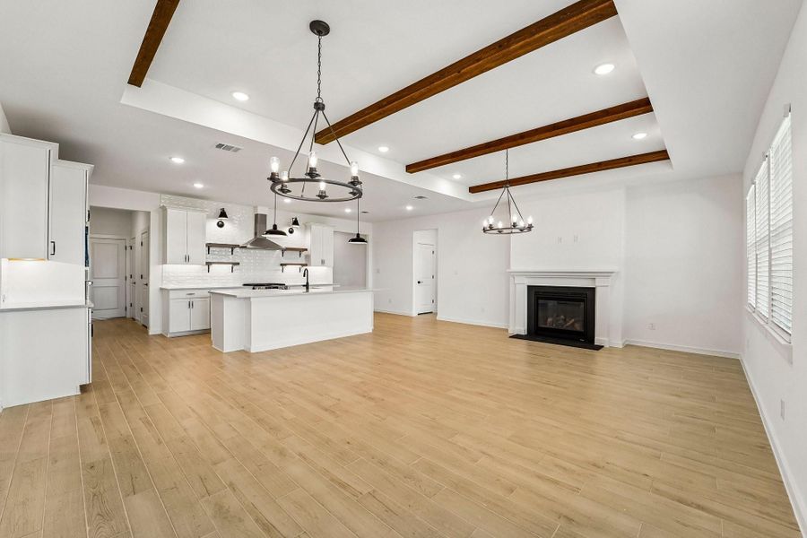 Bright and airy living area with decorative stained ceiling beams Bright and airy living area with decorative stained ceiling beams
