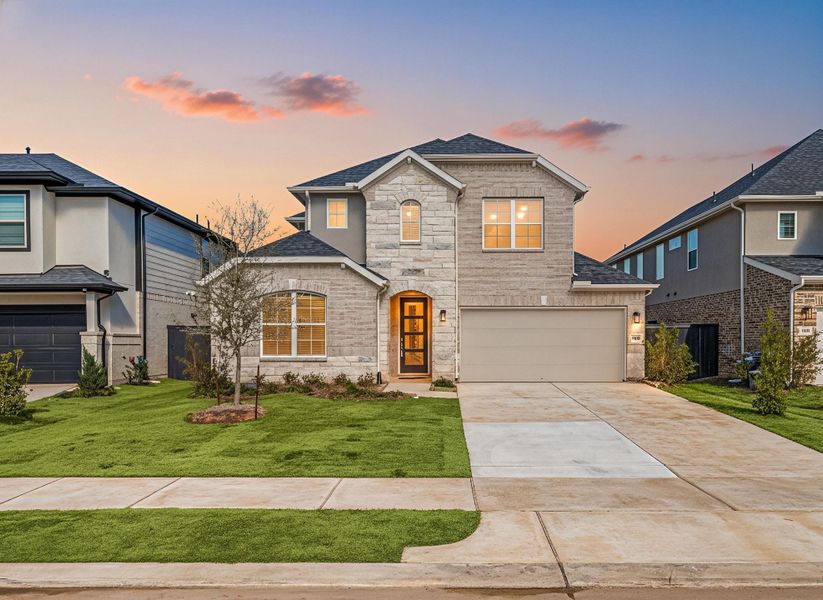 Front exterior of a new home in Harvest Green, Richmond, TX, highlighting curb appeal (Image 26). Front exterior of a new home in Harvest Green, Richmond, TX, highlighting curb appeal (Image 26).