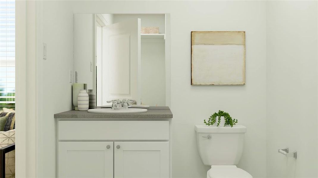 Half bath with vanity and toilet