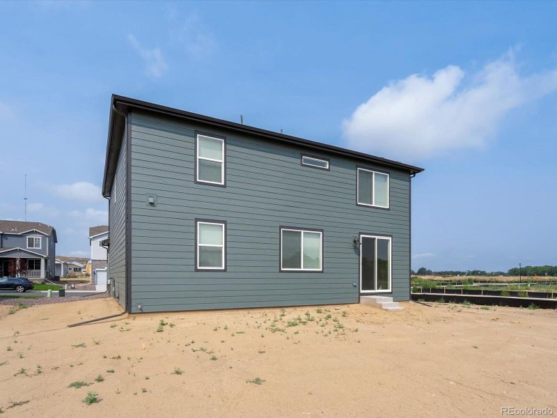 Front exterior of a new home in Poudre Heights: The Lakes Collection, Windsor, CO, highlighting curb appeal (Image 1).