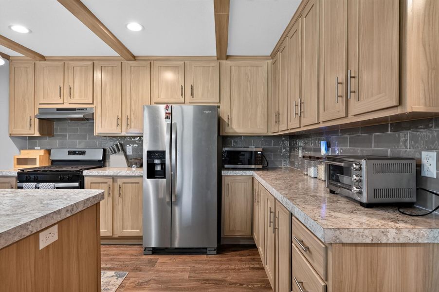 A well-equipped kitchen features a suite of stainless steel appliances, abundant cabinetry, and durable countertops for everyday living.