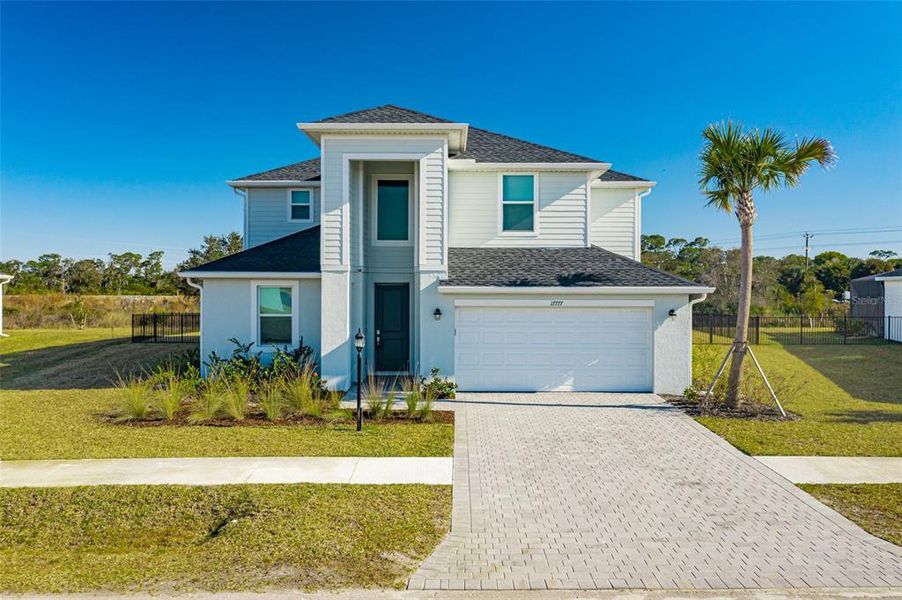Front exterior of a new home in , North Fort Myers, FL, highlighting curb appeal (Image 1). Front exterior of a new home in , North Fort Myers, FL, highlighting curb appeal (Image 1).