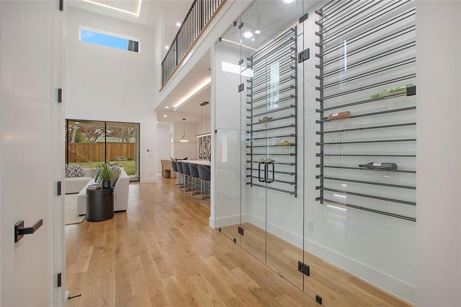 Hall featuring a towering ceiling and hardwood / wood-style flooring