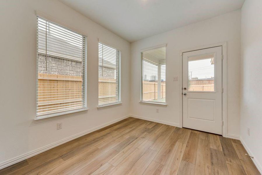 Doorway to outside featuring a wealth of natural light and light hardwood / wood-style floors