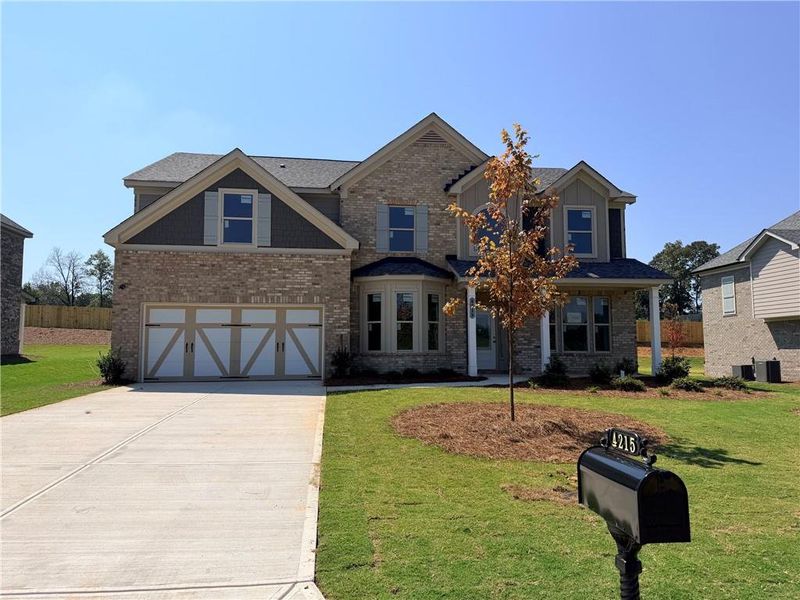 Front exterior of a new home in Sierra Lake, Cumming, GA, highlighting curb appeal (Image 1). Front exterior of a new home in Sierra Lake, Cumming, GA, highlighting curb appeal (Image 1).