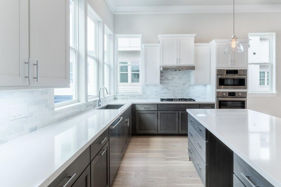 Expansive kitchen with wrap around windows and huge island.  Handsome, sophisticated finishes with high end furniture quality.