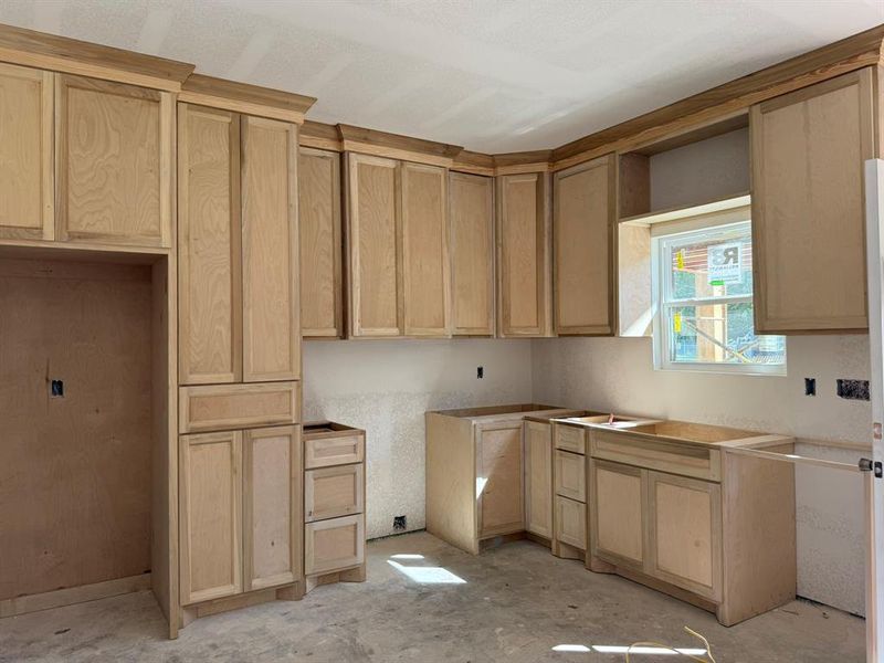 Kitchen featuring light brown cabinets
