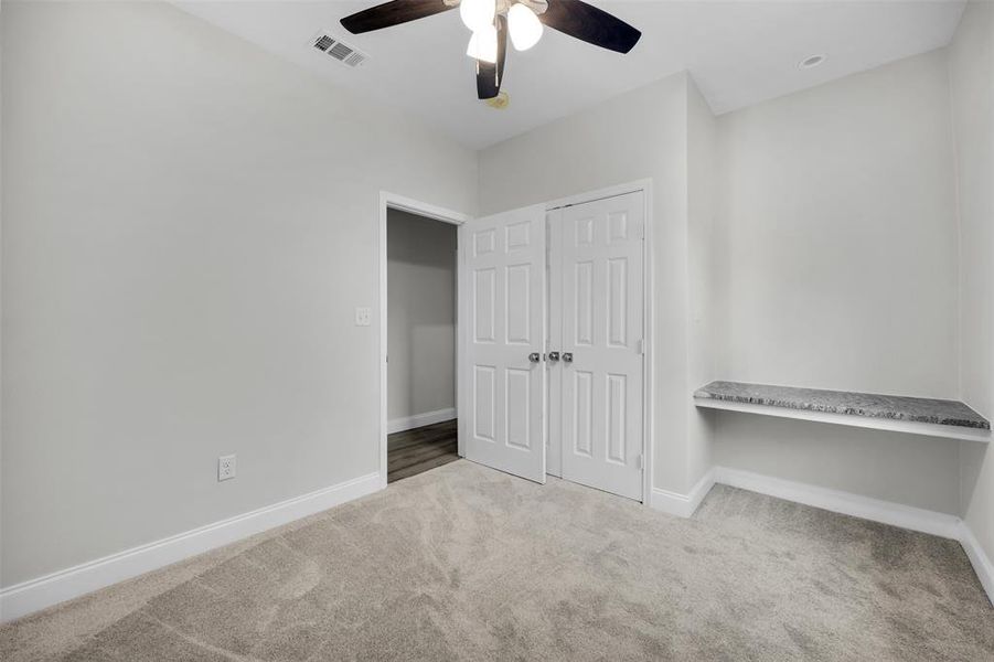 Unfurnished bedroom with a closet, baseboards, visible vents, ceiling fan, and carpet floors Unfurnished bedroom with a closet, baseboards, visible vents, ceiling fan, and carpet floors