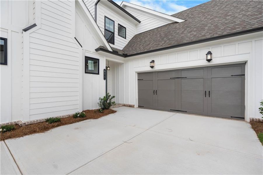 Front exterior of a new home in Promenade at Sawnee Village, Cumming, GA, highlighting curb appeal (Image 1).