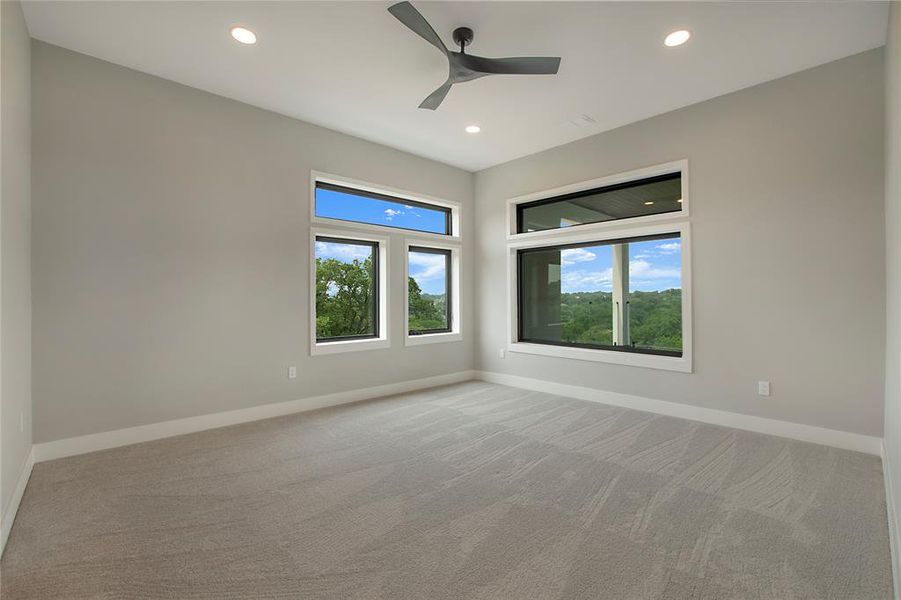 Unfurnished room featuring light colored carpet and ceiling fan