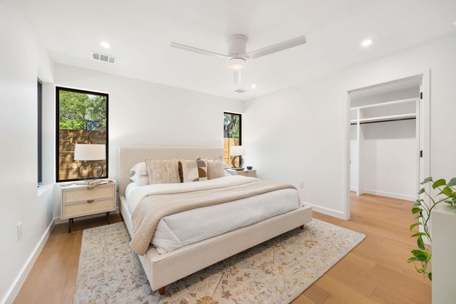 Bedroom with light wood finished floors, recessed lighting, and a ceiling fan