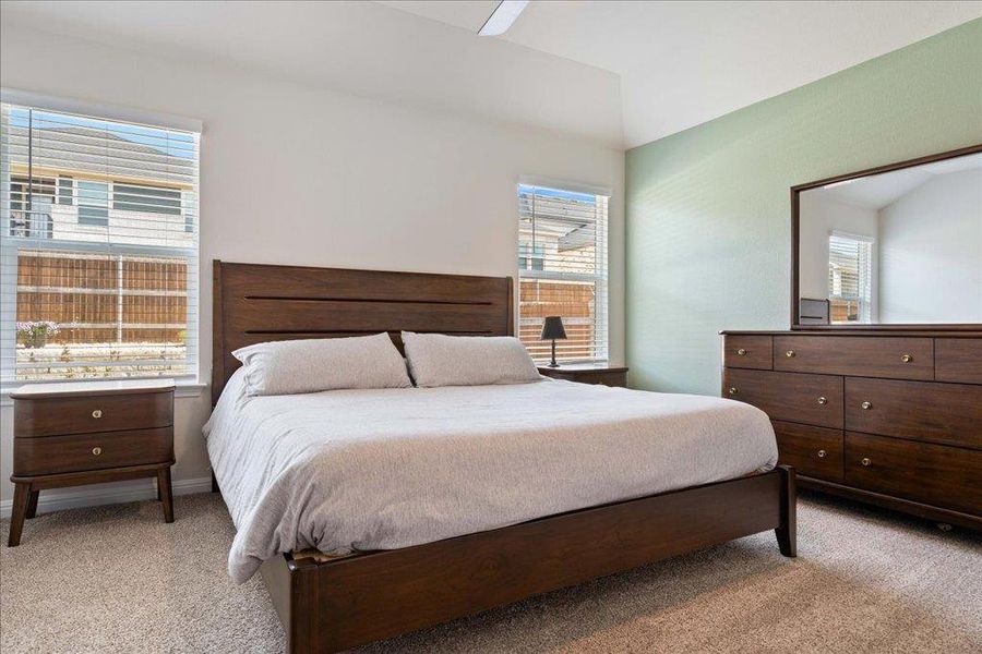 Bedroom featuring lofted ceiling and light colored carpet