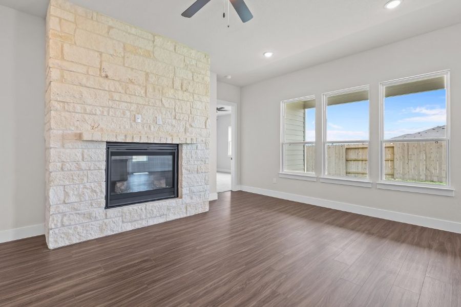 A room with a fireplace and a wood floor. A room with a fireplace and a wood floor.