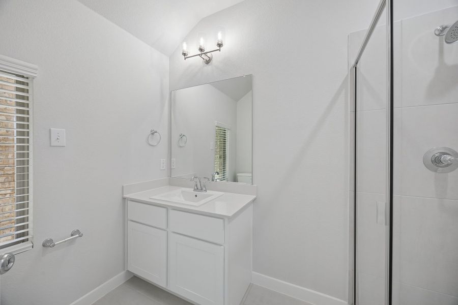 Bathroom in the Masters home plan by Trophy Signature Homes – REPRESENTATIVE PHOTO