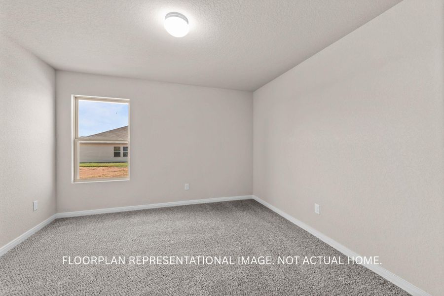 An inviting room features plush carpeting and a clear window offering serene neighborhood views.