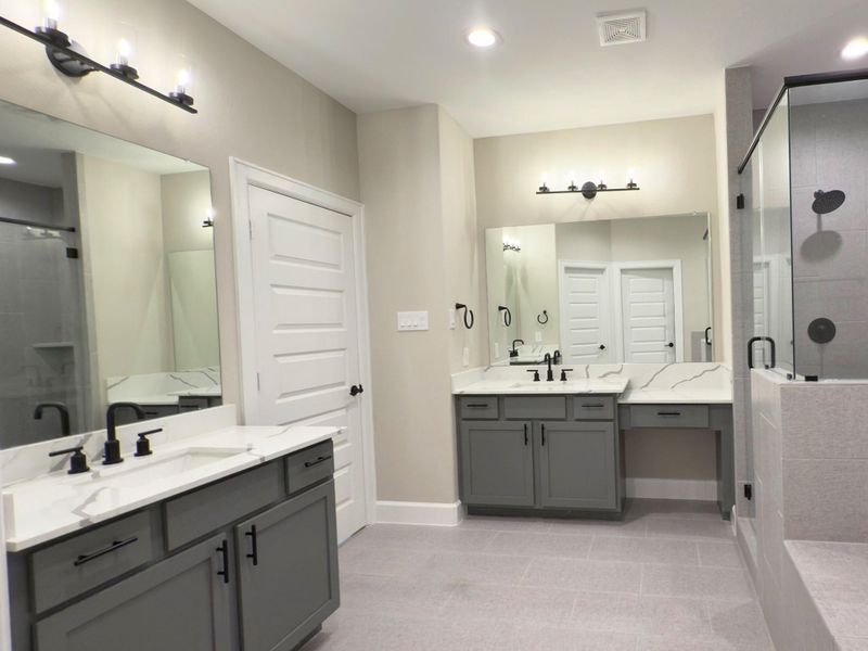 Enjoy the ultimate in convenience and style with the ROCburne primary bath’s dual vanities, offering personal space and a spa-like experience. Image depicts home as-is.