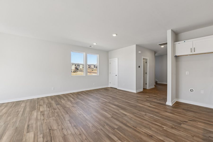A room with a wood floor and white walls.