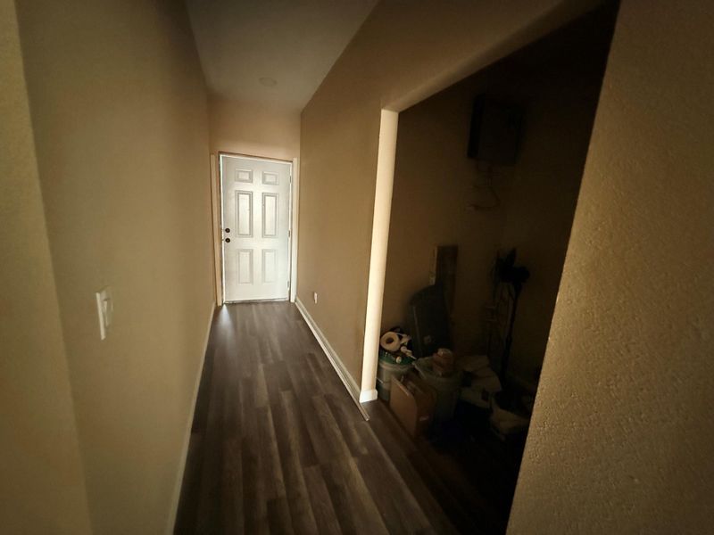 Hallway leading to laundry area and back door. Hallway leading to laundry area and back door.