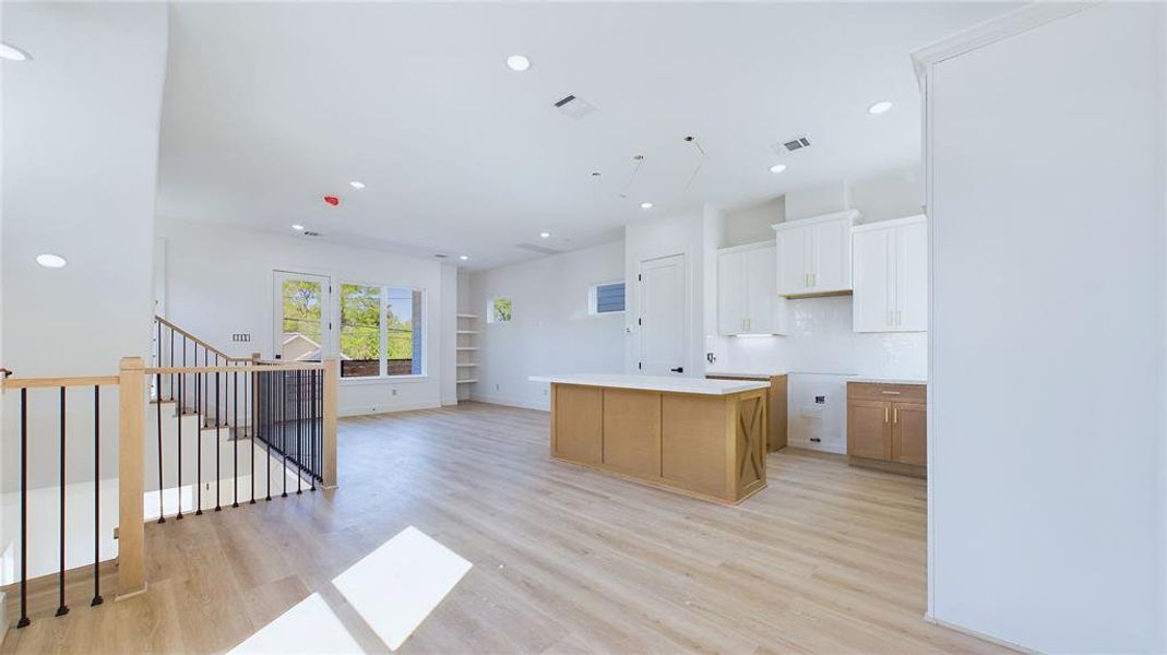 The spacious second floor boasts an open-concept layout, with the kitchen serving as the heart of the home, seamlessly connecting the living and dining areas.