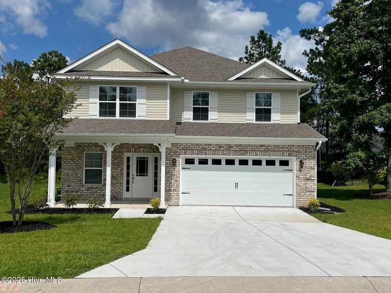 Front exterior of a new home in Palmetto Creek, Bolivia, NC, highlighting curb appeal (Image 1). Front exterior of a new home in Palmetto Creek, Bolivia, NC, highlighting curb appeal (Image 1).