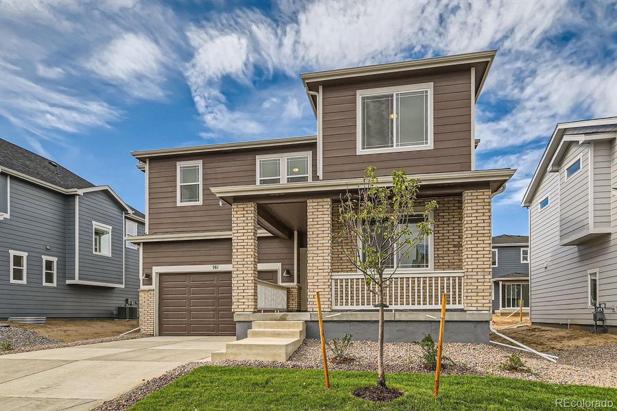 Front exterior of a new home in Wolf Creek Run, Strasburg, CO, highlighting curb appeal (Image 1).