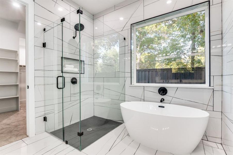 Bathroom with a freestanding tub, tile walls, a marble finish shower, and recessed lighting Bathroom with a freestanding tub, tile walls, a marble finish shower, and recessed lighting