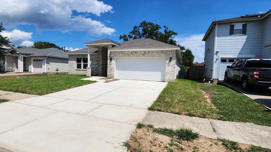 Front exterior of a new home in , Humble, TX, highlighting curb appeal (Image 12).