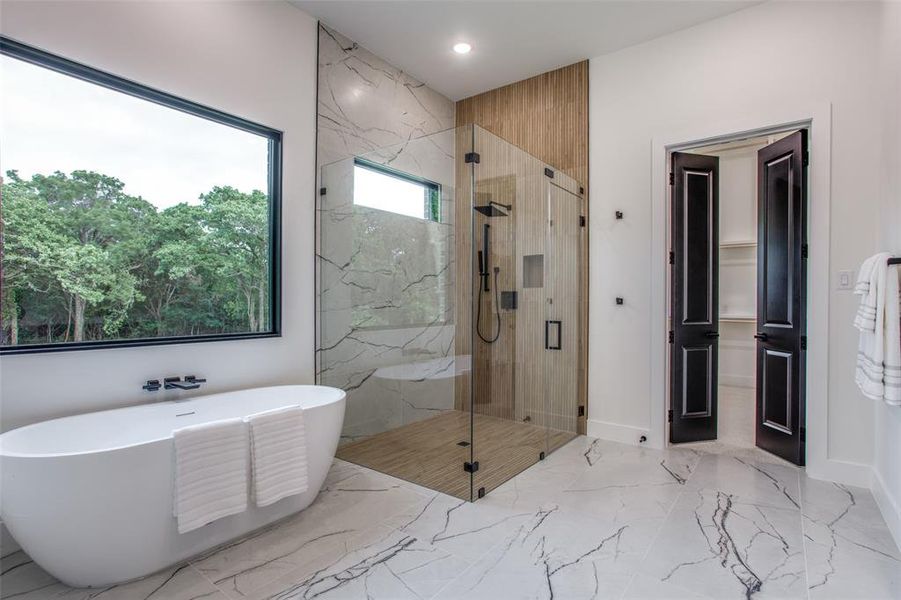 Bathroom featuring shower with separate bathtub