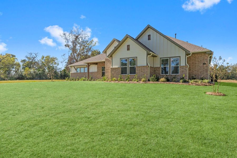 Front exterior of a new home in Homestead Hill, New Waverly, TX, highlighting curb appeal (Image 22).