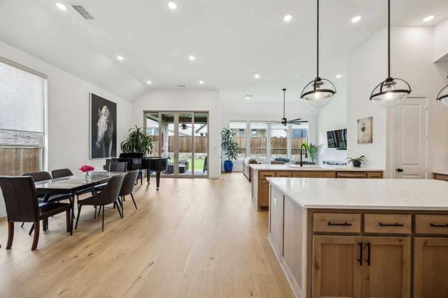 Kitchen featuring recessed lighting, light wood-style flooring, light countertops, vaulted ceiling, and ceiling fan